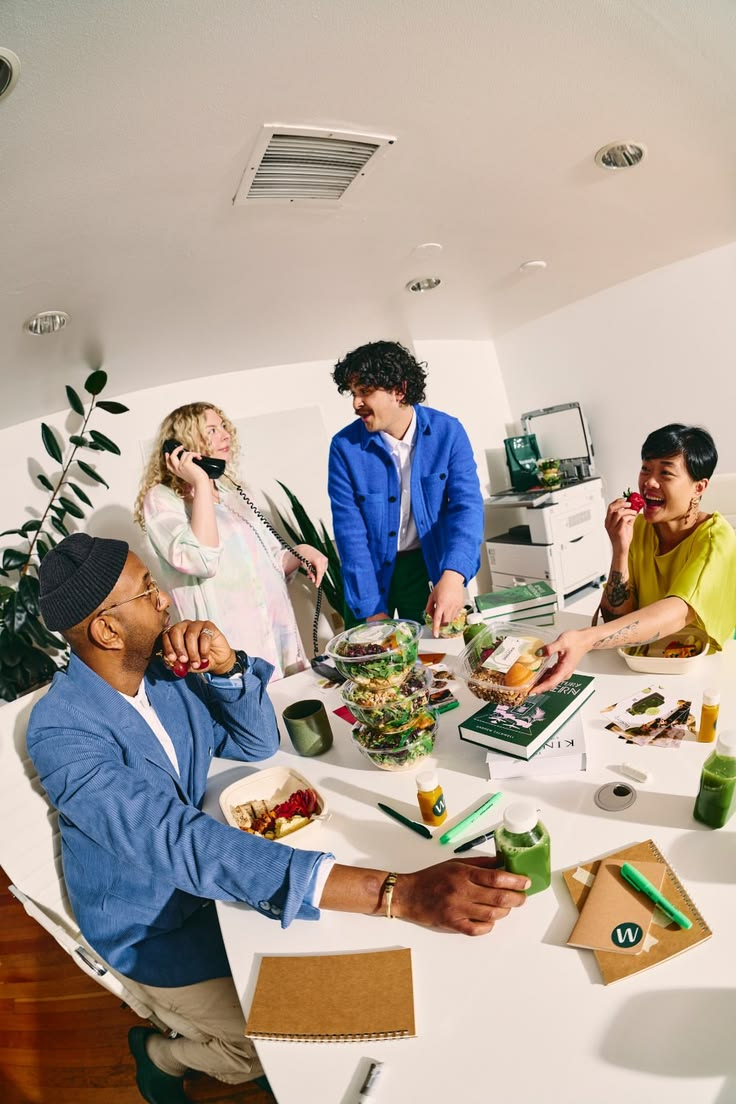 Colleagues sharing lunch and conversation in a bright office